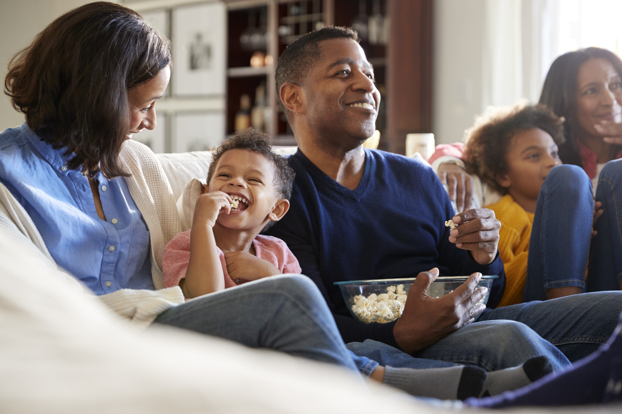 family enjoying popcorn at home together