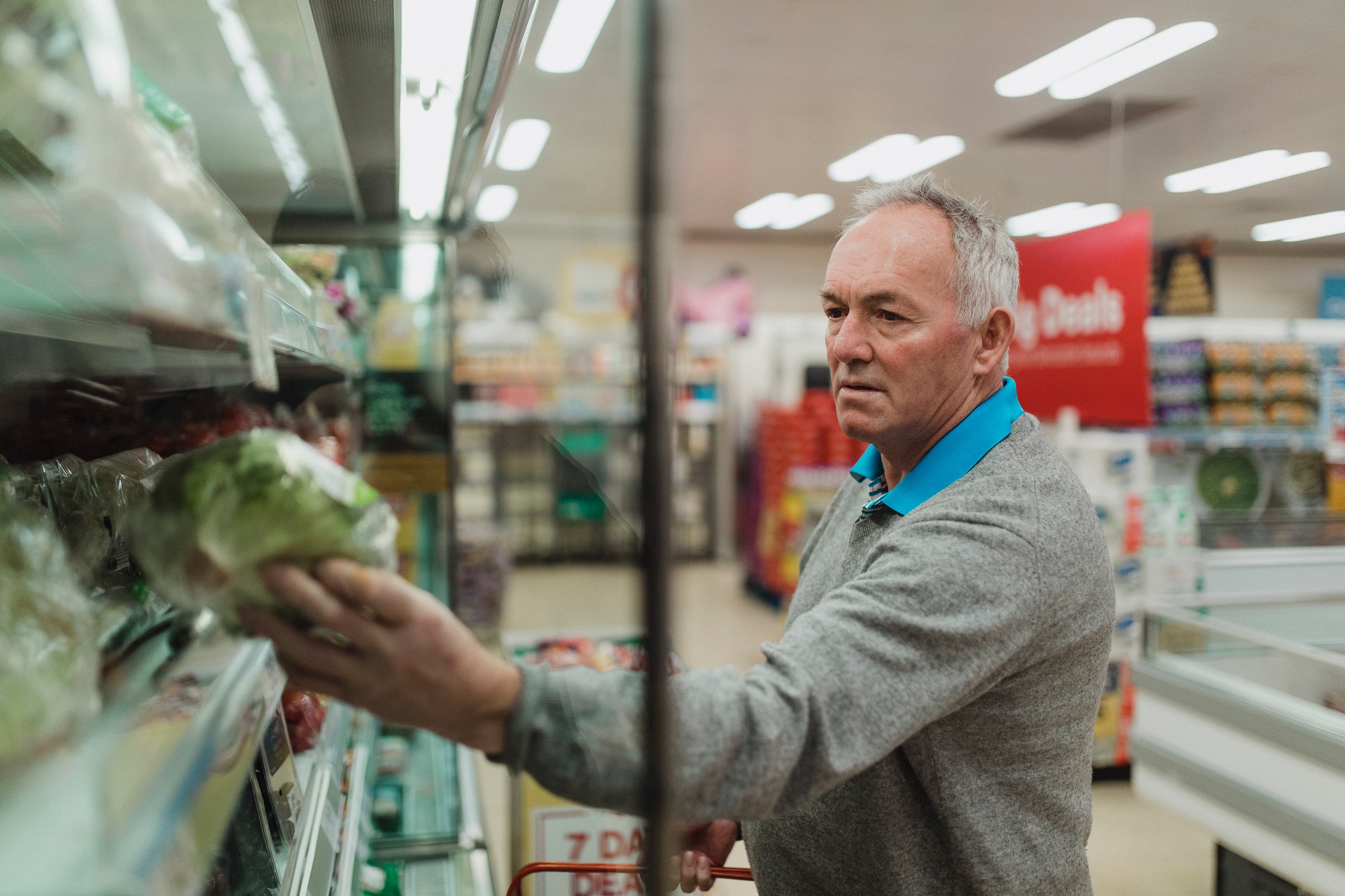 senior man at grocery store