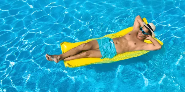 Person relaxing in a swimming pool