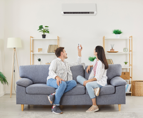 Couple relaxing in living room with air conditioning